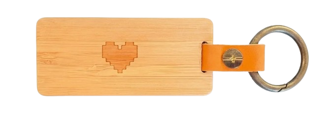 Back of the same KEEP keychain — bamboo body with a pixel-heart engraved at the center.