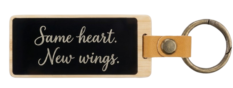 A KEEP keychain engraved with the words Same heart, new wings.