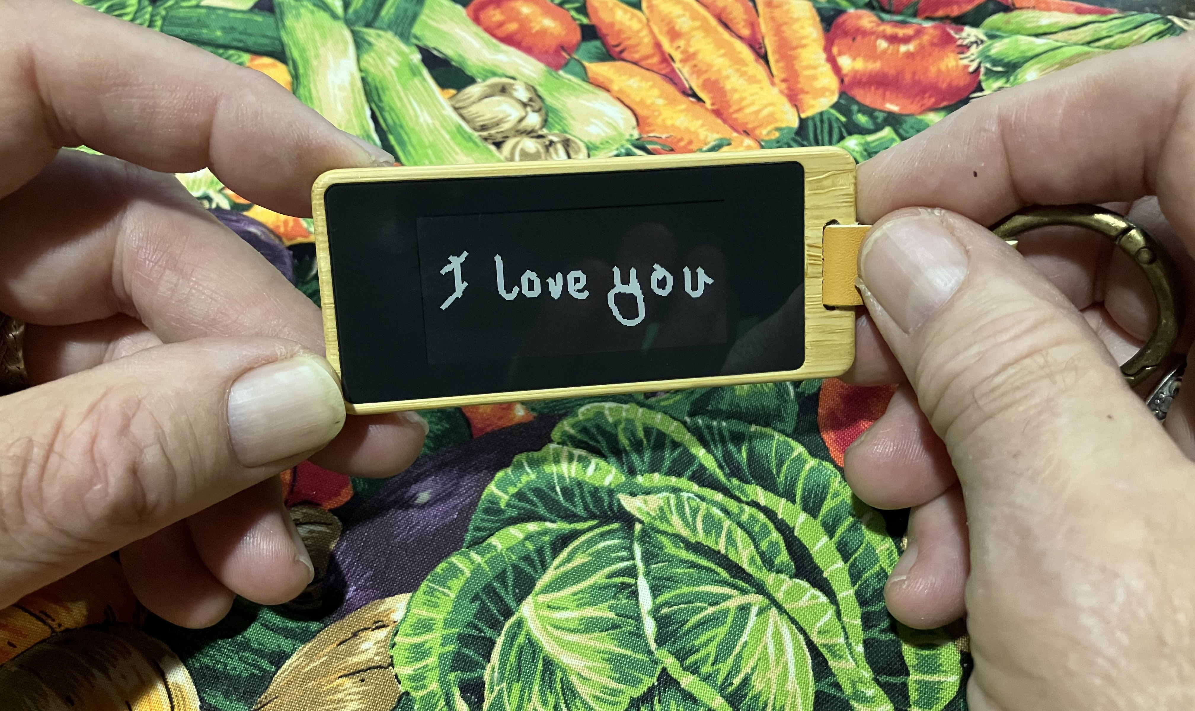 A KEEP keychain held in a beta tester's hands.