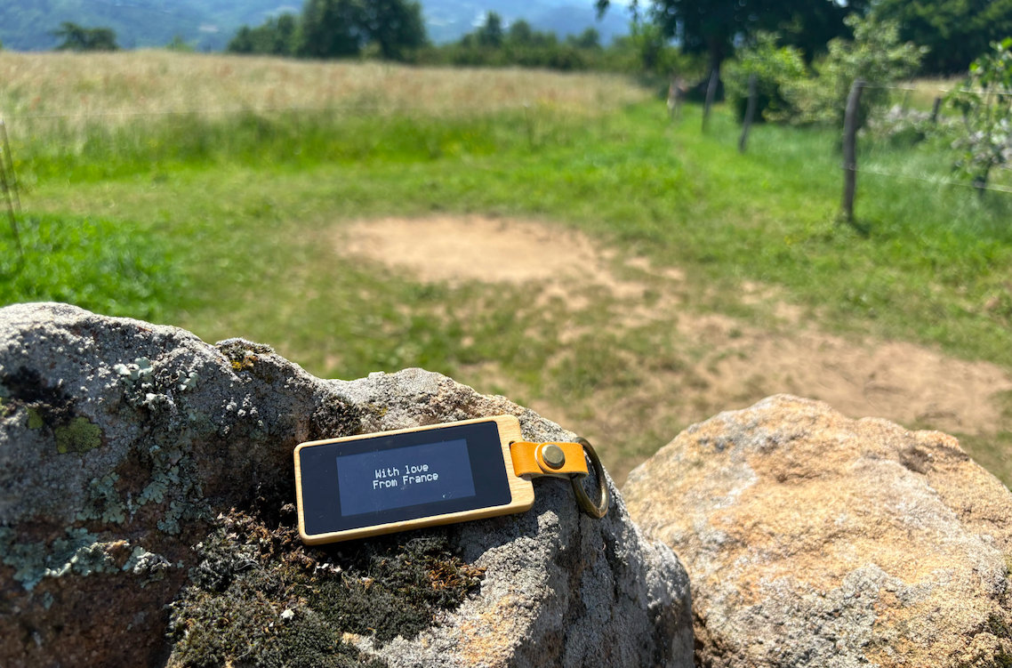 A KEEP on a rock in the Alps, screen reading With love From France.