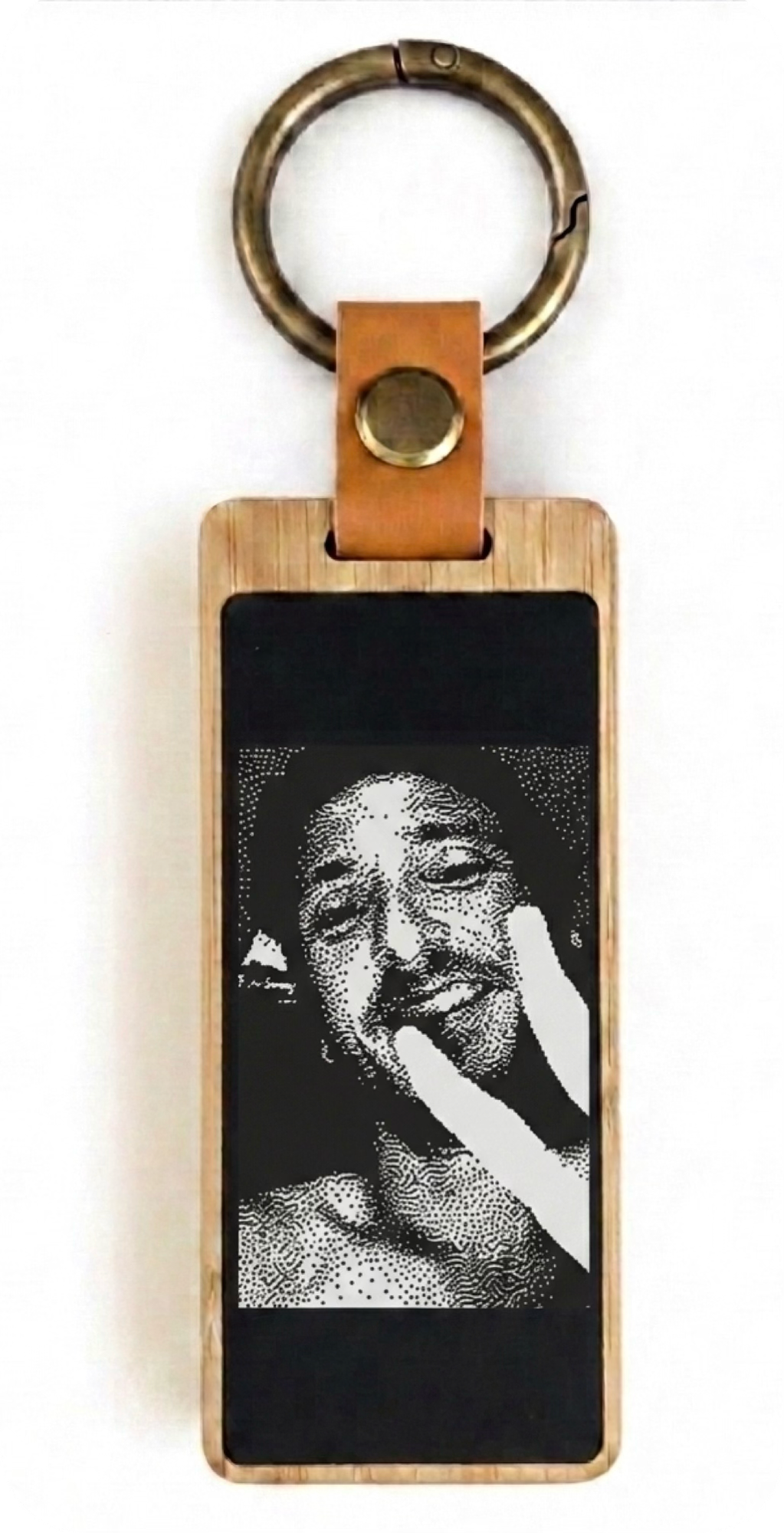 A KEEP keychain showing that same black-and-white selfie in e-ink.
