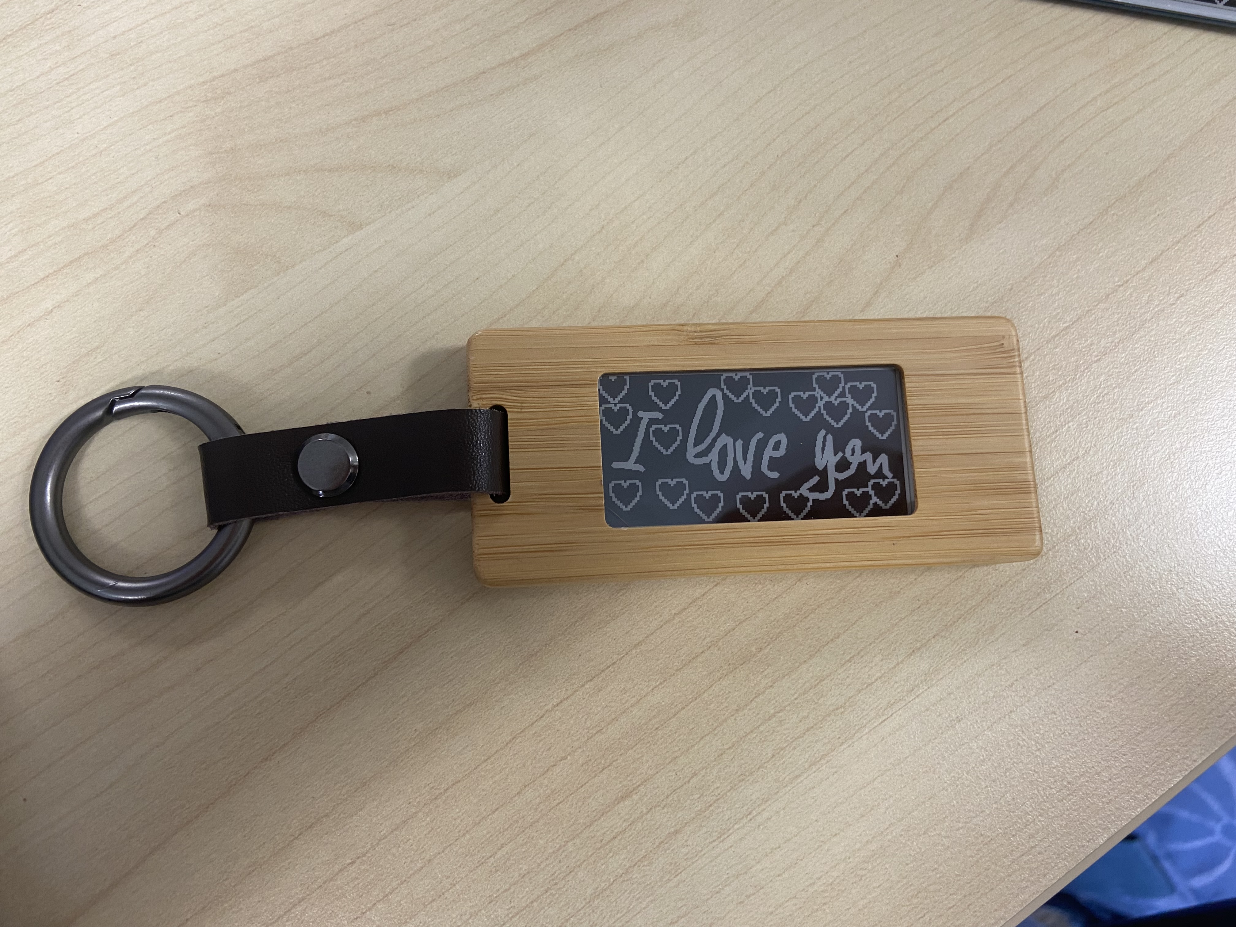 The first full KEEP prototype on a desk, screen hand-written I love you.